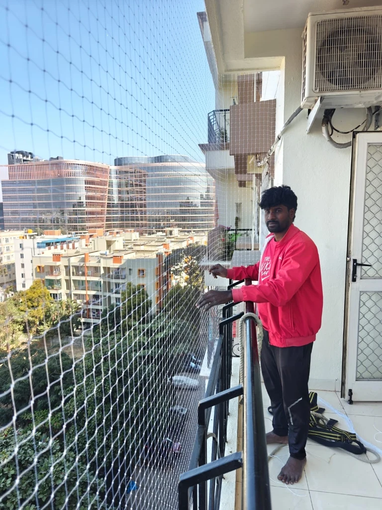 Ruthi technician inspecting balcony safety net