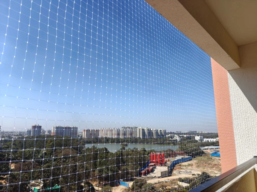 Modern apartment balcony safety net in Bengaluru with panoramic lake view